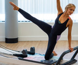 REFORMERMAT Female Practising Reformer Pilates On Durable Micro-fibre Gym Mat
